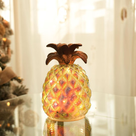 Varavīksnes efekta stikla ananāsa lampa.